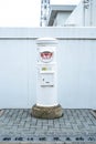White Post in front of Inubosaki Lighthouse in Choshi Prefecture Royalty Free Stock Photo