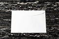 White postal envelope on a black wooden table. Abstract background for design