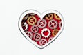 White postcard with heart shape made of gears on red background Royalty Free Stock Photo