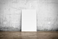 White poster on concrete wall and wood floor Royalty Free Stock Photo