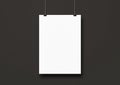 White poster hanging on a black wall with clips Royalty Free Stock Photo