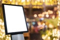 White poster mockup with black frame stand in front of blurred cafe restaurant background Royalty Free Stock Photo