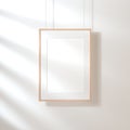 White poster with wooden frame Mockup hanging on the wall