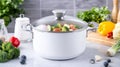 White pot with mixed vegetables in modern kitchen setting, cooking concept Royalty Free Stock Photo