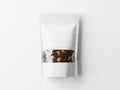 White pouch containing assorted dried tea leaves isolated on white background Royalty Free Stock Photo