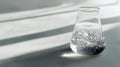 White powder dissolving in clear liquid inside glass flask on textured surface with soft shadows and light Royalty Free Stock Photo