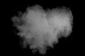 White powder explosion against dark background.Heart shape liked.