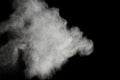 White powder explosion on black background.Stopping the movement of white powder on dark background.