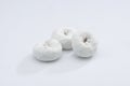 White Powdered Sugar Donuts on a White Background