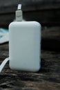 white power bank electronic with data cable on woodrn table Royalty Free Stock Photo