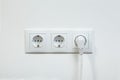 White power plug plugged in a electric socket Royalty Free Stock Photo