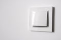 White power switch on white wall Royalty Free Stock Photo