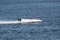 White powerboat go fast along the blue water Royalty Free Stock Photo