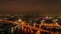 White Prayoon Pagoda, Memorial Bridge, and Phra Pok Klao Bridge with buildings and curve of Chao Phraya River at night. Urban city Royalty Free Stock Photo