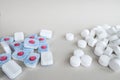 White pressed salt tablets and colored dishwasher capsules close-up. Place for text