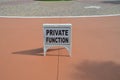 White private function sign on red sidewalk