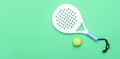 White professional paddle tennis racket and ball on mint color background. Horizontal sport theme poster, greeting cards, headers,