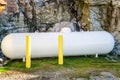 White Propane Tank with Rocks in Background