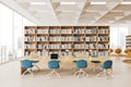 White public library reading room interior with bookcases and blue chairs Royalty Free Stock Photo
