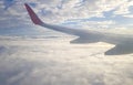 White puffy Clouds and blue sky, view from an airplane window. Royalty Free Stock Photo