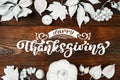 White pumpkin, berries and leaves on a wooden autumn background with text Happy Thanksgiving. Mockup Greeting card for