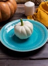 White pumpkin on blue plate with napkin on wood background Royalty Free Stock Photo