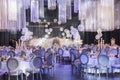 White and purple adorned event venue with elegant silver chandeliers