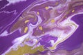 White and purple colors flow down and mix with each other and gold dust. Abstract ink background. Royalty Free Stock Photo
