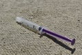 White purple syringe and gray cloth background. Royalty Free Stock Photo