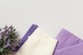 White and purple waffle towels and a flower plant on a gray background Royalty Free Stock Photo