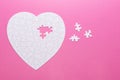 White puzzle heart on pink background. Top view Royalty Free Stock Photo