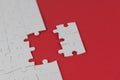 White puzzle with missing piece on red background. Business concept. Finish what you start. Team work and partnership.
