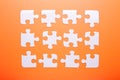 White puzzle on orange background. Top view Royalty Free Stock Photo