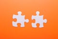 White puzzle on orange background. Top view Royalty Free Stock Photo