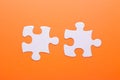 White puzzle on orange background. Top view Royalty Free Stock Photo