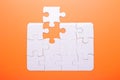 White puzzle on orange background. Top view Royalty Free Stock Photo