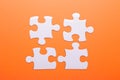 White puzzle on orange background. Top view Royalty Free Stock Photo