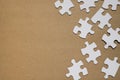 white puzzle pieces brown paper backdrop. High quality photo Royalty Free Stock Photo