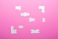 White puzzle on pink background. Top view Royalty Free Stock Photo