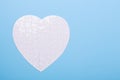 White puzzle in shape of heart on blue background Jigsaw Concept treatment of heart disease pills Royalty Free Stock Photo