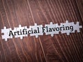 White puzzle with the word Artificial Flavoring