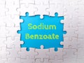 White puzzle with the word Sodium Benzoate on a blue background