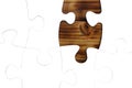 White puzzles lie on a wooden background
