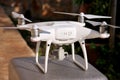 White quadcopter Drone with 4K digital camera on stand is ready for take off to fly in air to take photos, record footage. Royalty Free Stock Photo