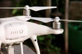 White quadcopter Drone with 4K digital camera on stand is ready for take off to fly in air to take photos, record footage. Royalty Free Stock Photo