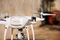 White quadcopter Drone with 4K digital camera on stand is ready for take off to fly in air to take photos, record footage. Royalty Free Stock Photo