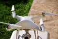 White quadcopter Drone with 4K digital camera on stand is ready for take off to fly in air to take photos, record footage. Royalty Free Stock Photo