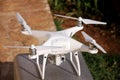 White quadcopter Drone with 4K digital camera on stand is ready for take off to fly in air to take photos, record footage. Royalty Free Stock Photo