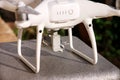 White quadcopter Drone with 4K digital camera on stand is ready for take off to fly in air to take photos, record footage. Royalty Free Stock Photo