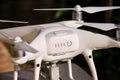 White quadcopter Drone with 4K digital camera on stand is ready for take off to fly in air to take photos, record footage. Royalty Free Stock Photo